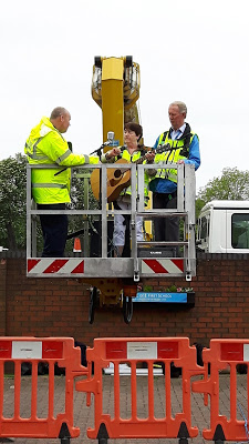 getting ready to perform as the cherry picker starts to raise up 30m in a cherry picker singing for the daft as a brush garden party Me 33 metres up singing to the crowd